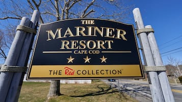 A sign for The Mariner Resort in Cape Cod, featuring a prominent logo and the text "The Red Collection".