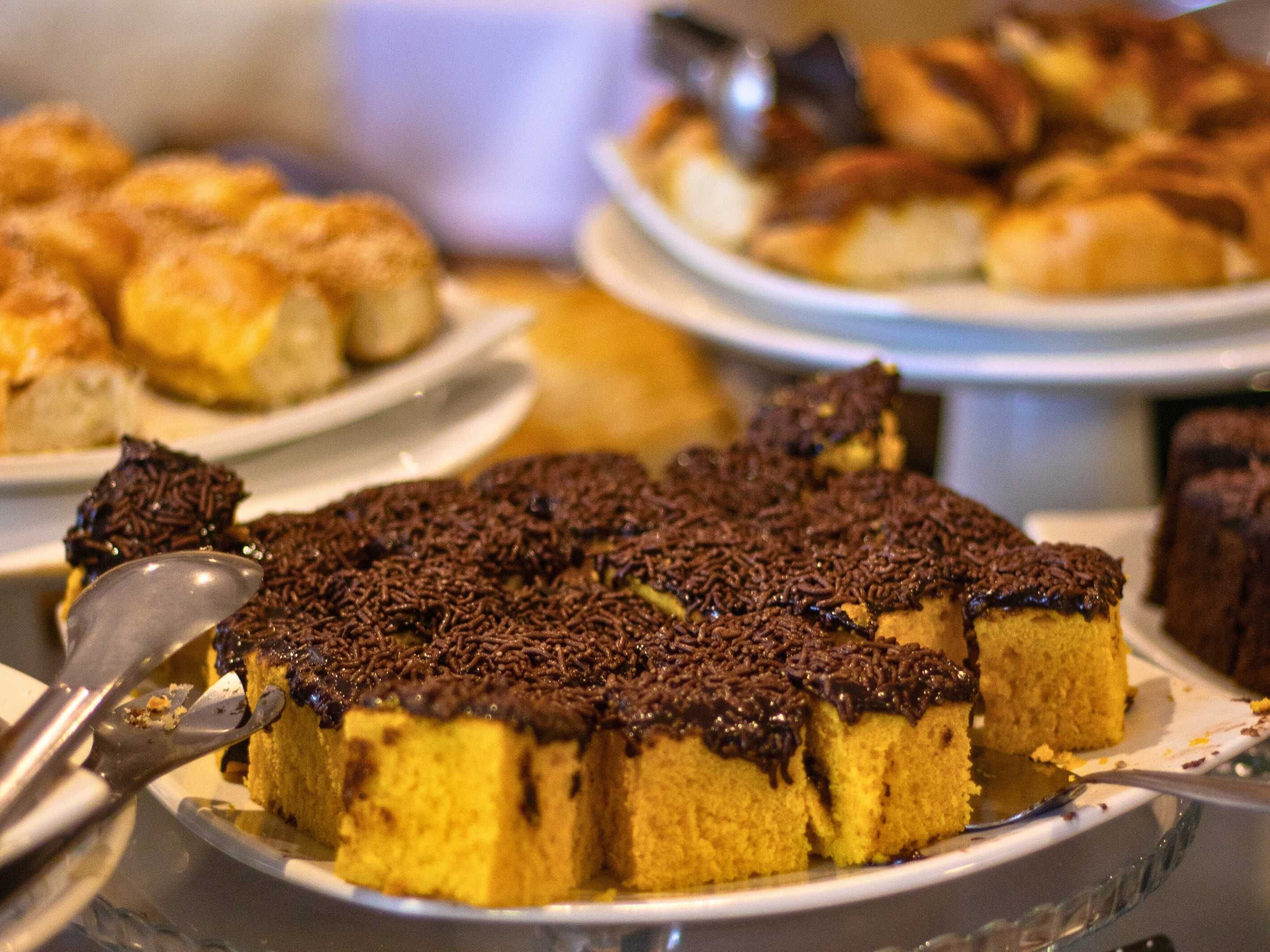 A dessert buffet with various cakes and pastries.
