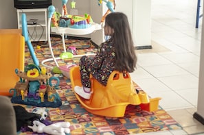 Children can play and explore in this fun room with a variety of toys and play structures.