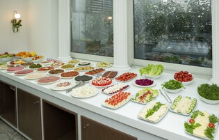 Una mesa de bufé con diferentes platillos y vista al exterior.