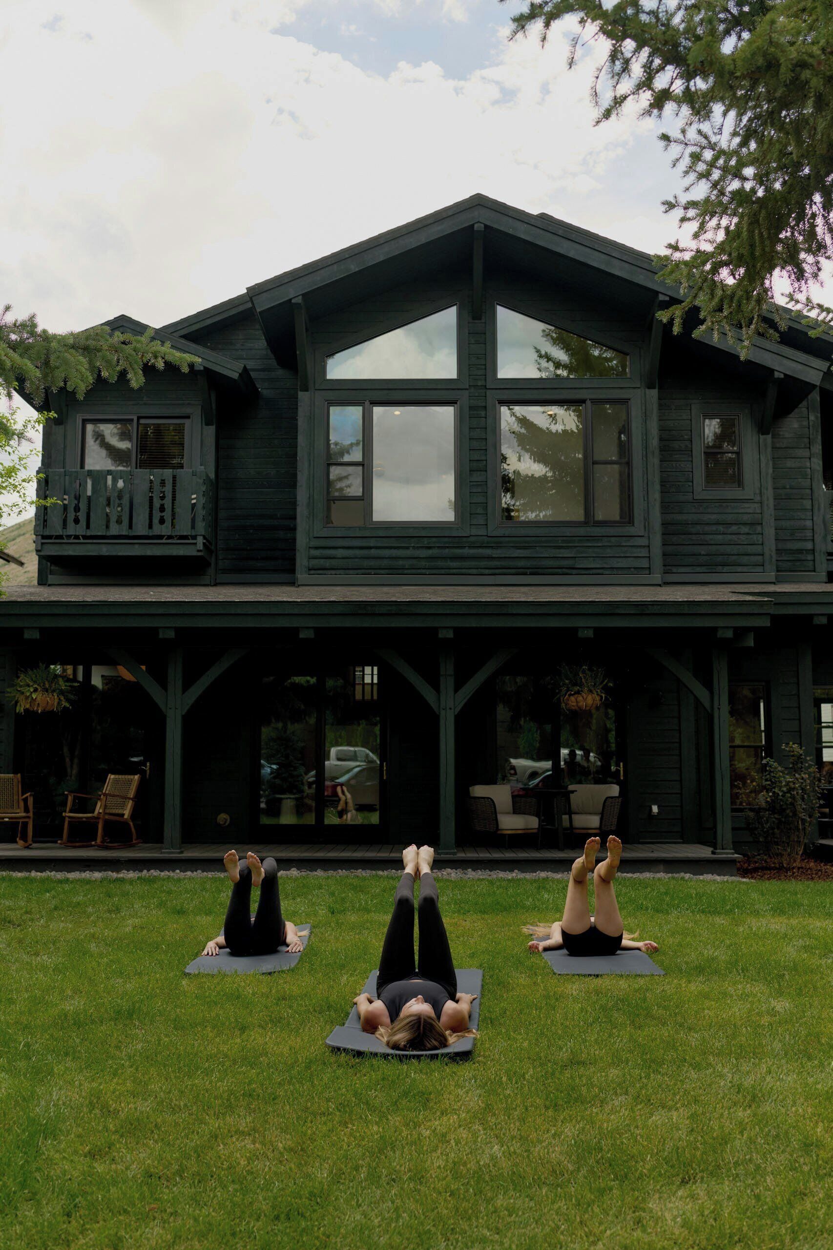 A two-story house with a porch and a grassy yard.