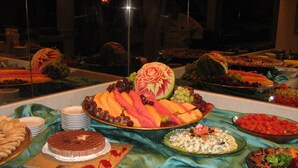 A buffet with various food items including fruits, vegetables, and desserts. - Jerusalem Gold Hotel (Jerusalem)