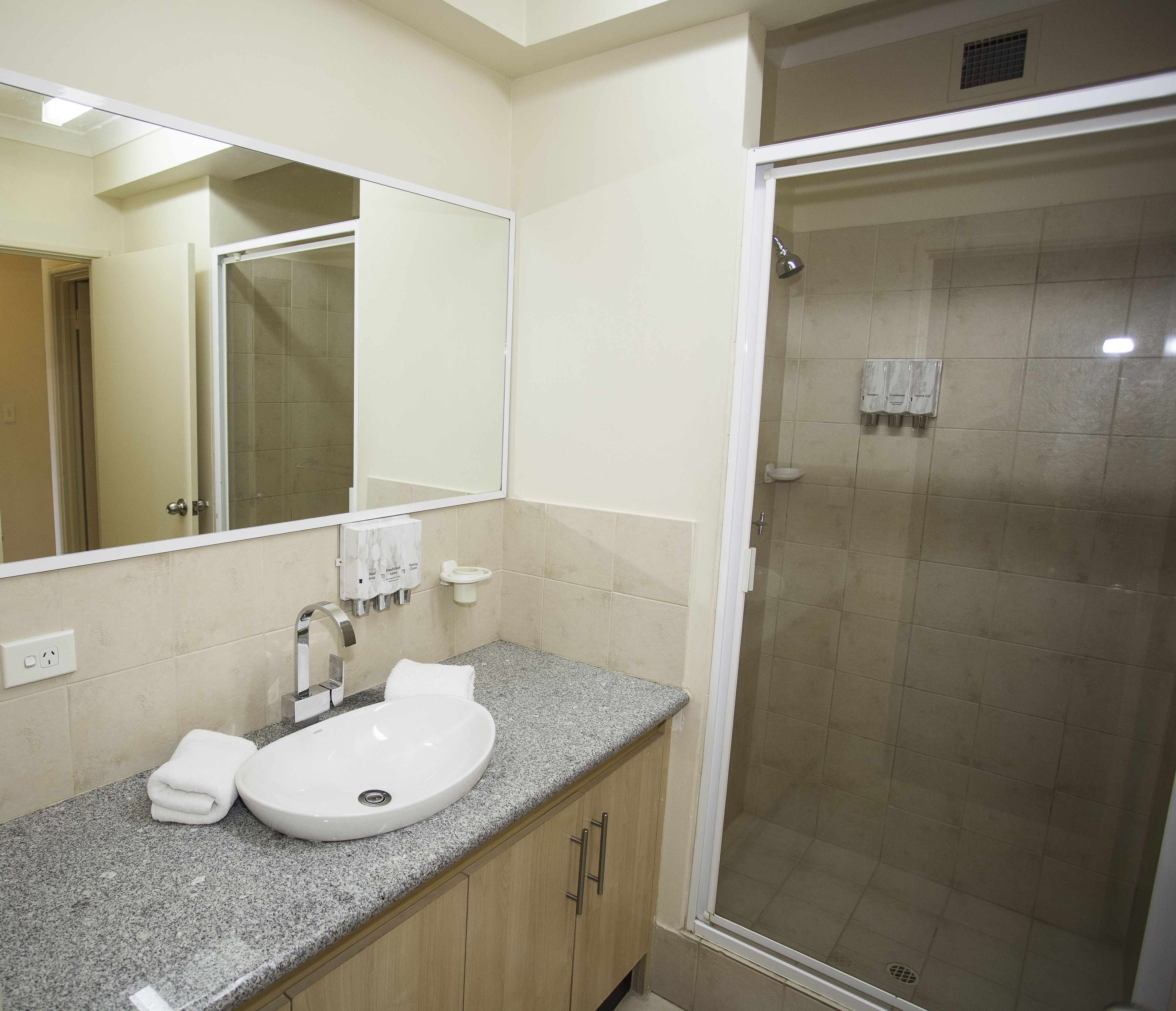 shower, hair dryer, towels, shampoo