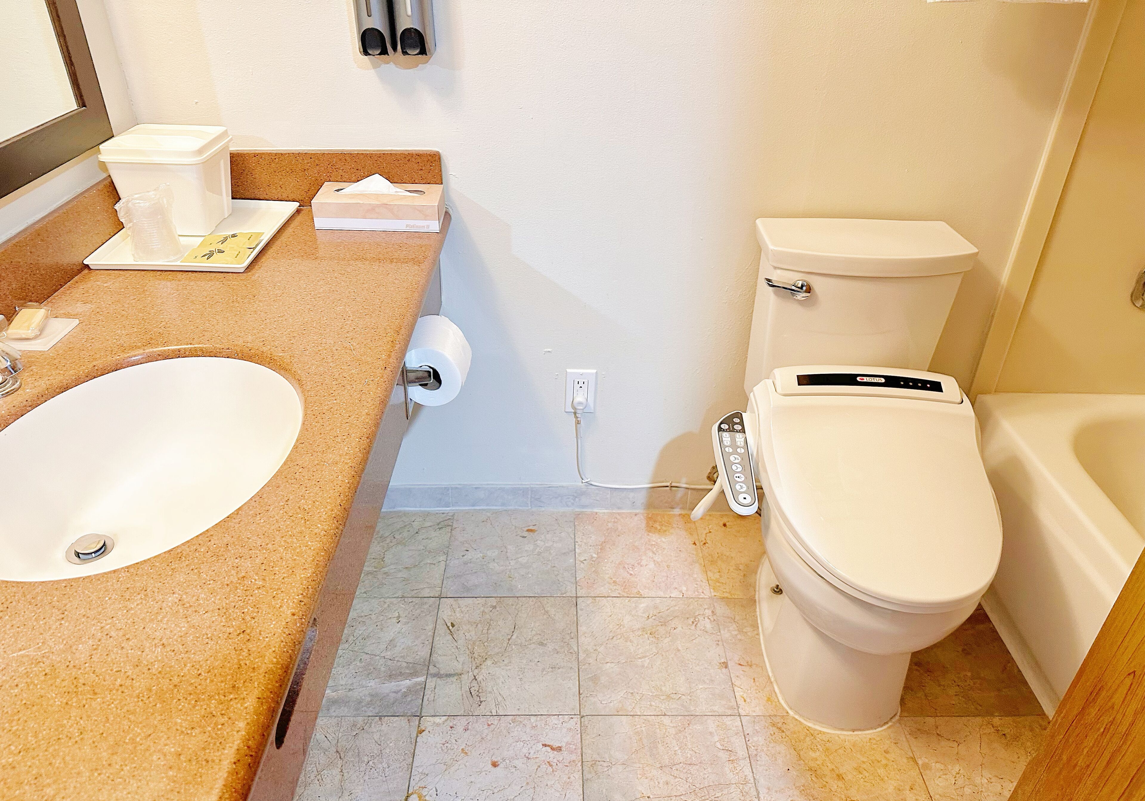 A bathroom with a sink, toilet, and bathtub.