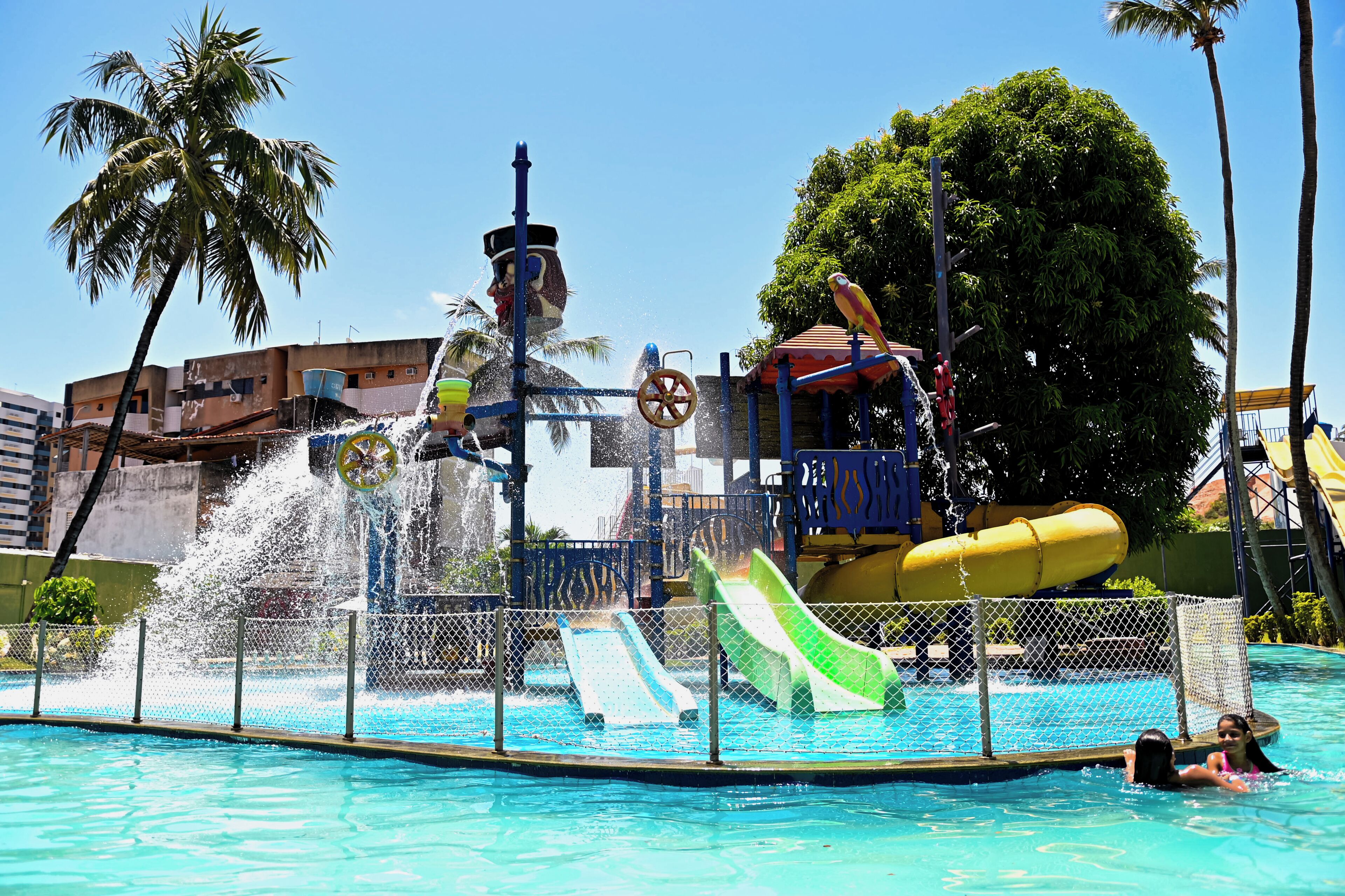 A water park with multiple slides and a large water fountain.