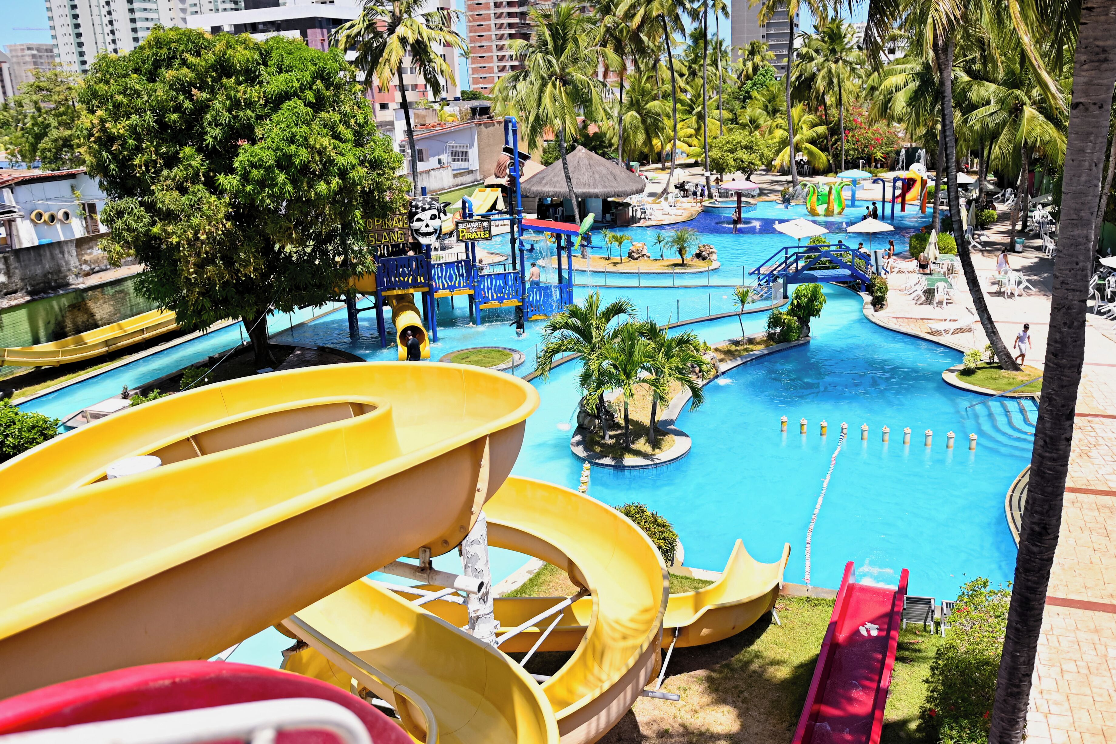 A water park with multiple slides and a large pool.