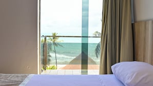 A room with a bed, a view of the ocean, and a balcony with a glass railing. - Matsubara Acqua Park Hotel (Maceió)