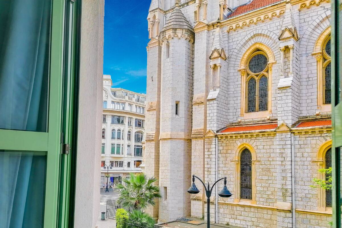 A view of a historic building with arched windows and a stone facade.
