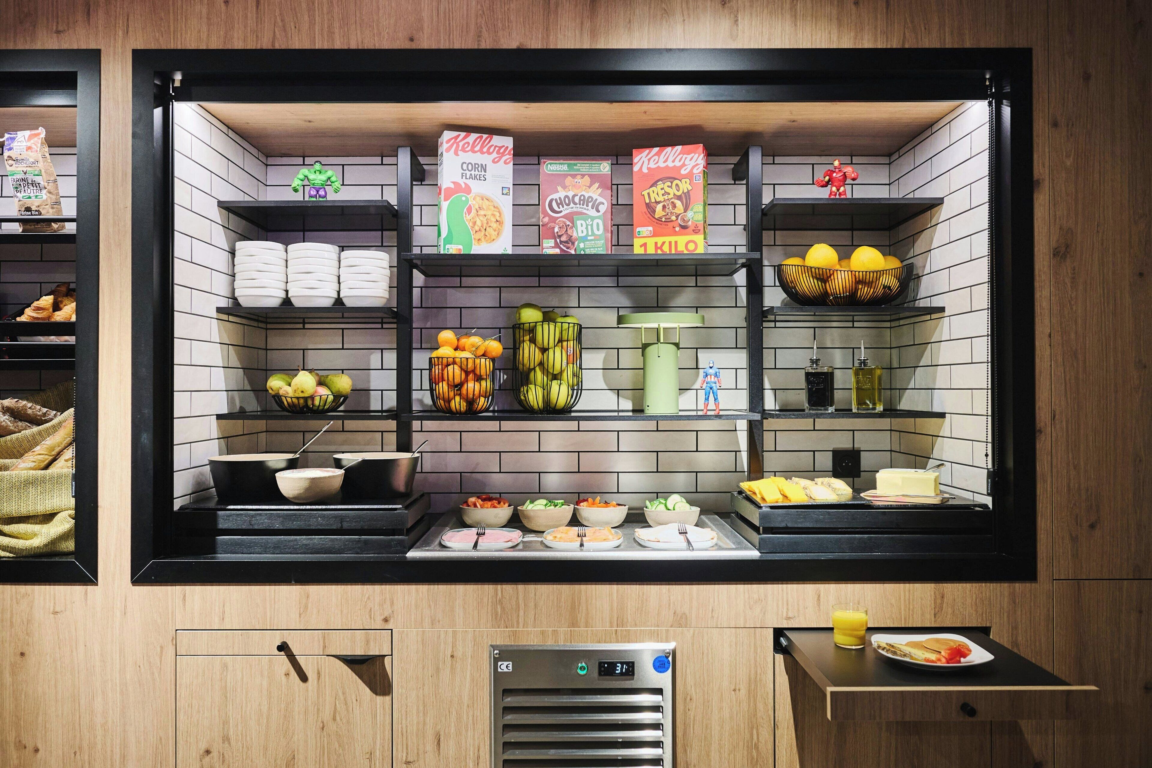 A breakfast bar with various food items and beverages.
