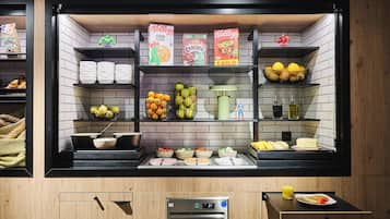 A breakfast bar with various food items and beverages.