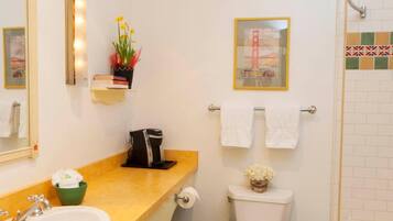 A compact bathroom with a sink, toilet, and bathtub.
