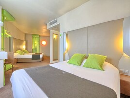 Premium bedding, desk, laptop workspace, blackout drapes