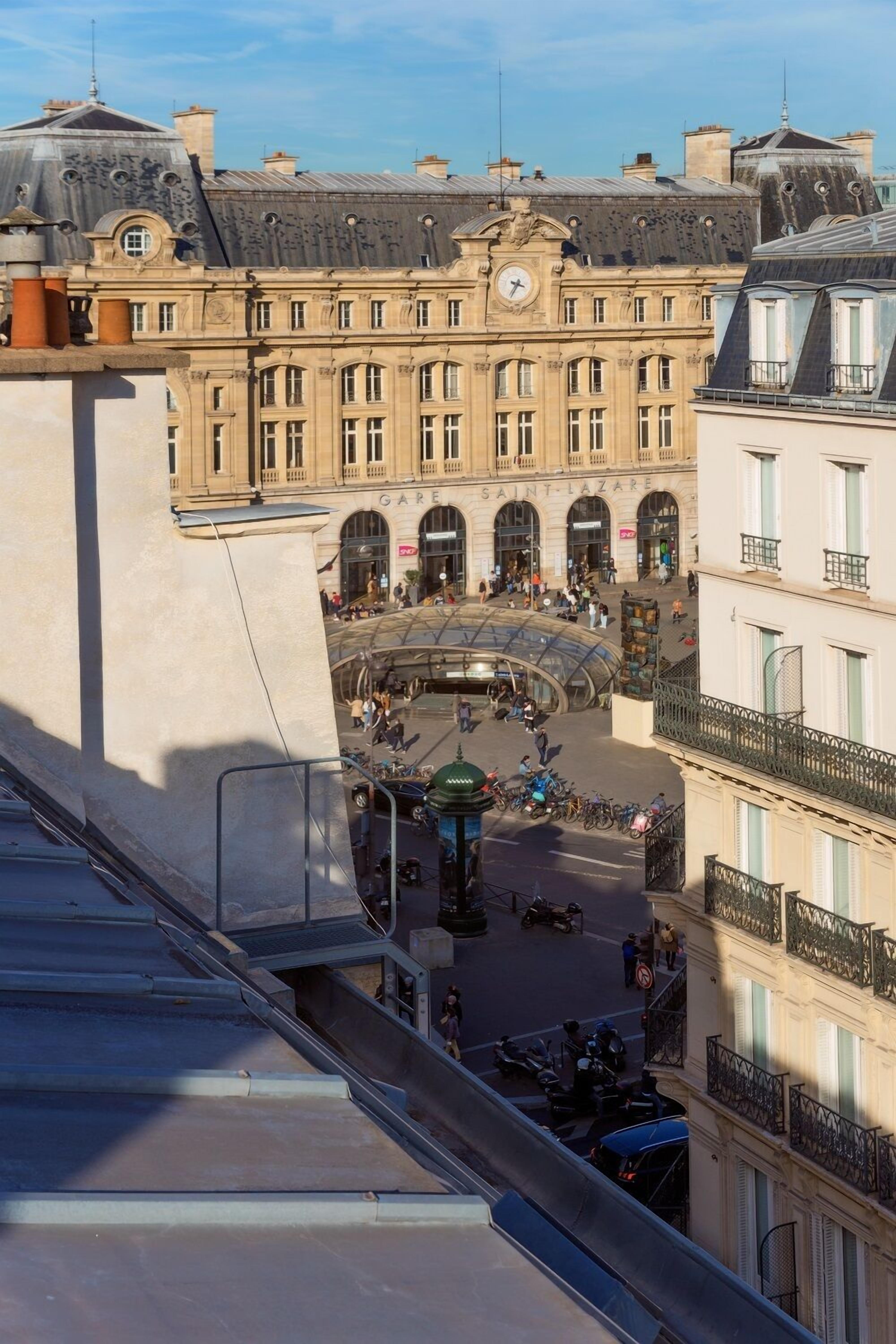 A historic building with a central courtyard, arched entrances, and a clock tower.
