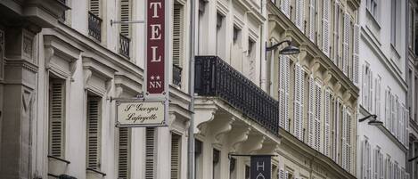 A building with a 'HOTEL' sign and a 'HOTEL' sign with stars.