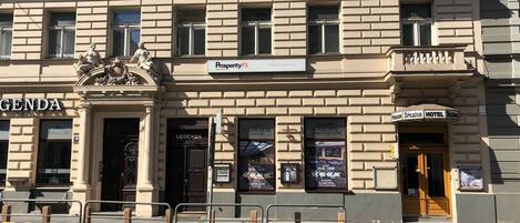 A building with a sign for 'Prosperity FS' and 'Legenda' on the ground floor.