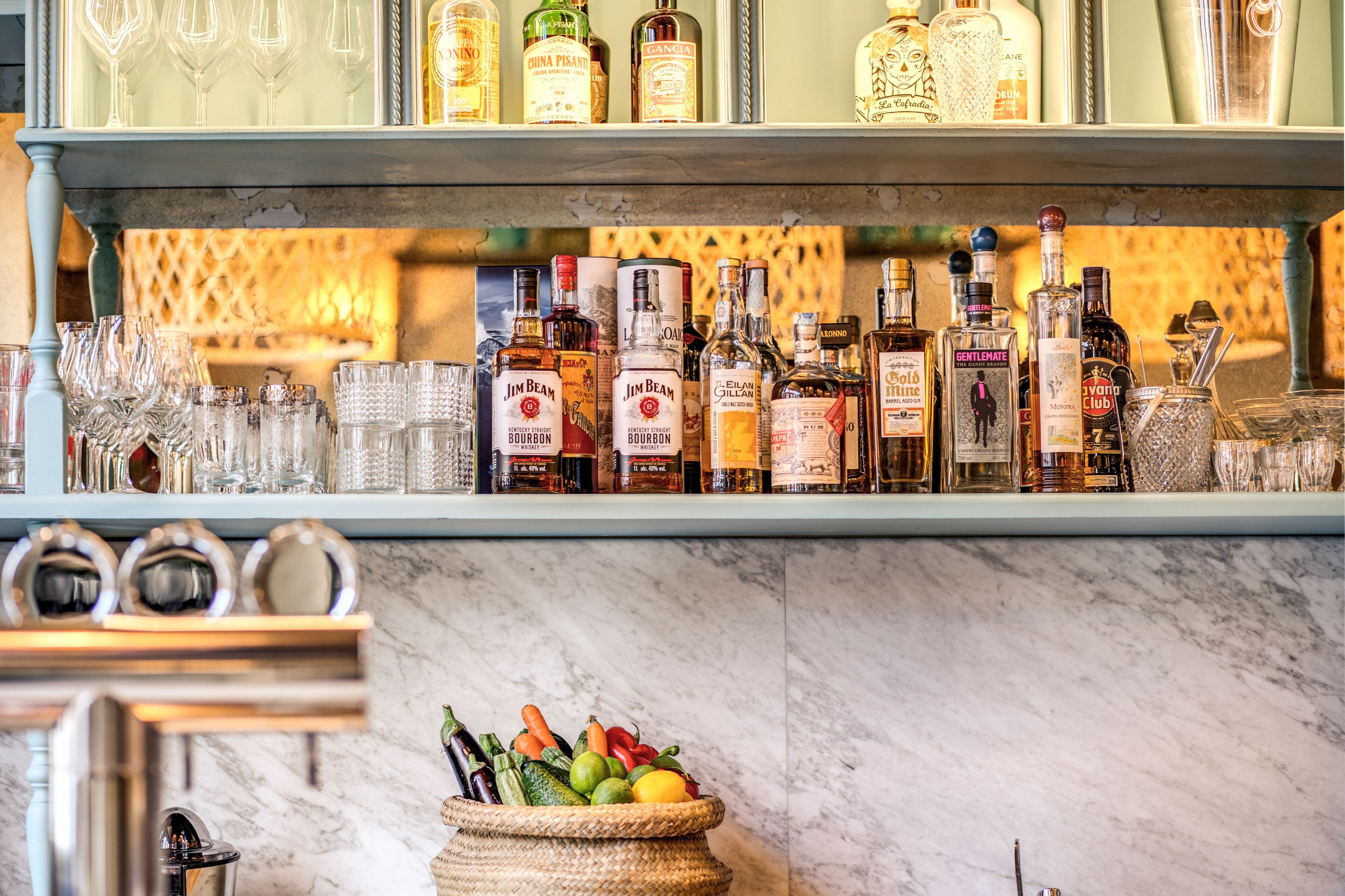 A bar area with various liquor bottles and glasses.
