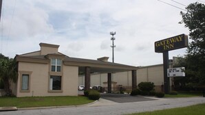 A Gateway Inn building with a covered entrance, a sign indicating King Beds Sun to Thur rates, and a parking area. - Gateway Inn - Savannah (Savannah)
