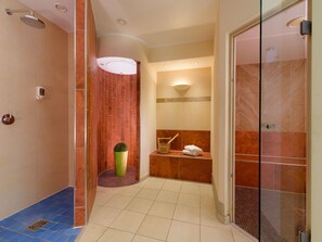 A modern bathroom with a shower, a toilet, a sink, and a glass-enclosed shower area. - ibis Styles Leipzig (Schkeuditz)