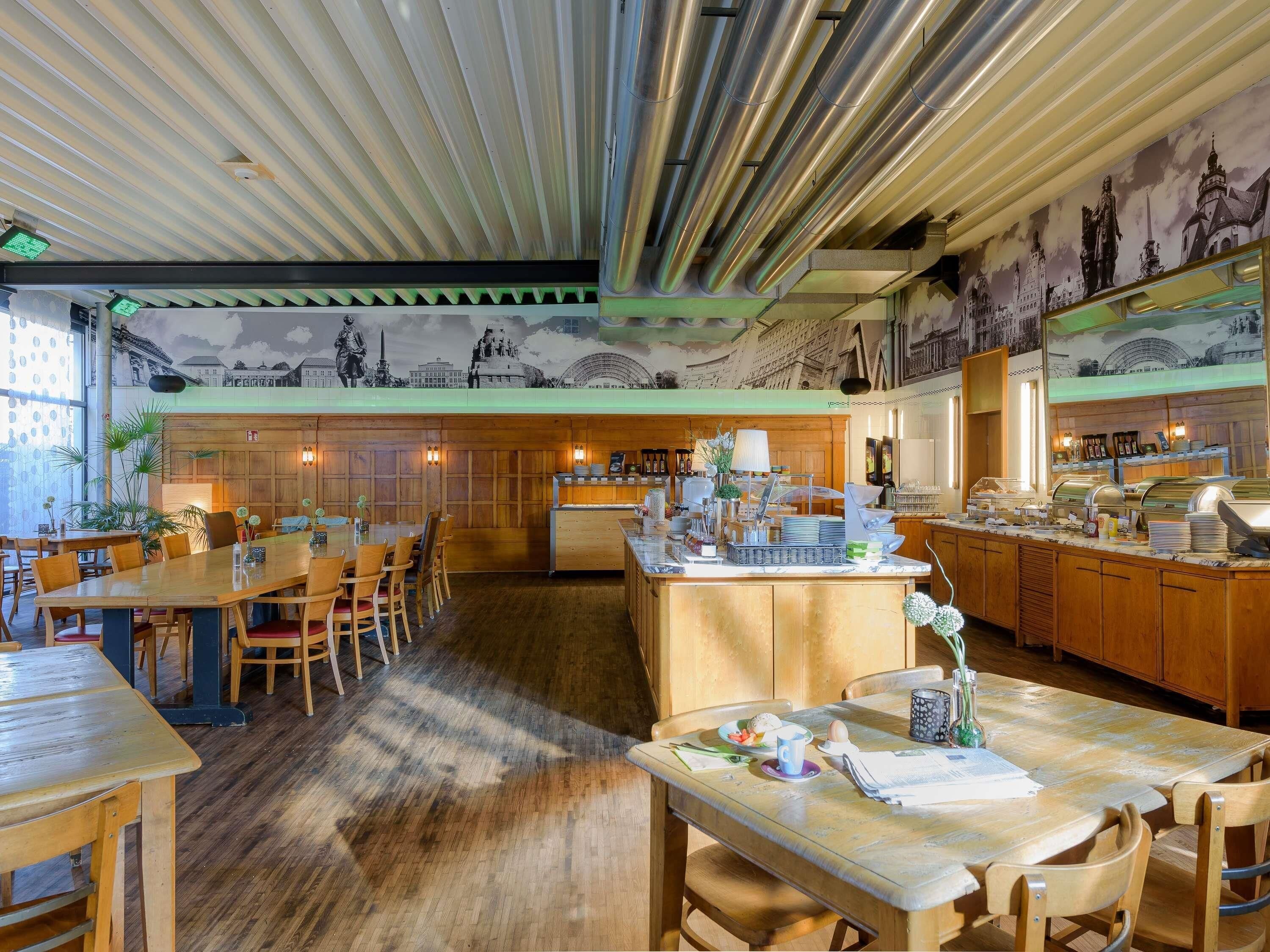 A restaurant with wooden furniture, a buffet area, and a mural of historical buildings on the wall.