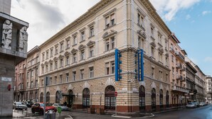A historic building with multiple stories, large windows, and a prominent entrance. - City Hotel Unio Superior (Budapest)