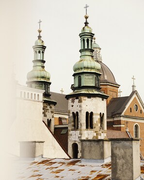 A historic building with two prominent towers, a brick facade, and a large dome. - Hotel Copernicus (Kraków)