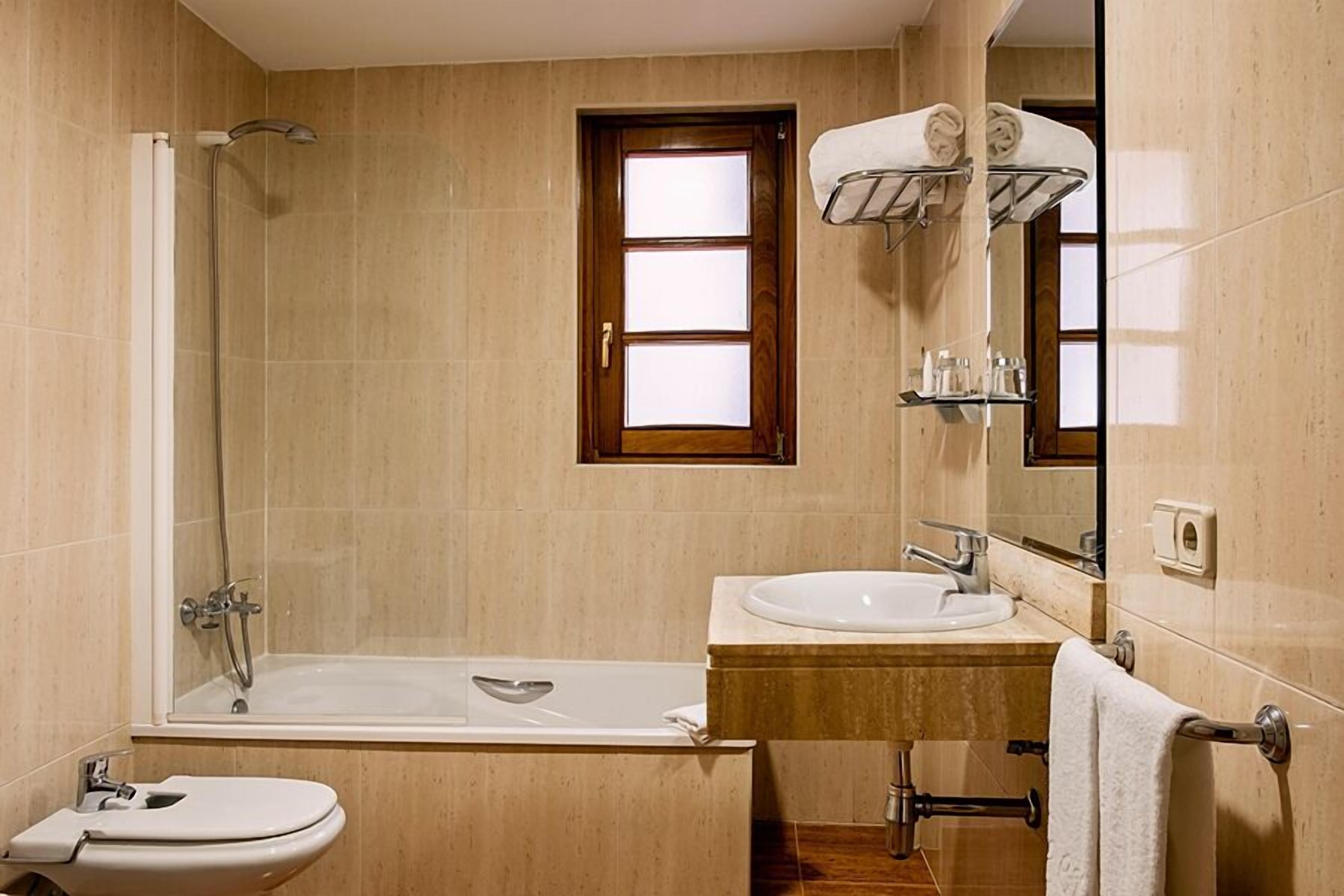 deep-soaking bathtub, eco-friendly toiletries, hair dryer, towels