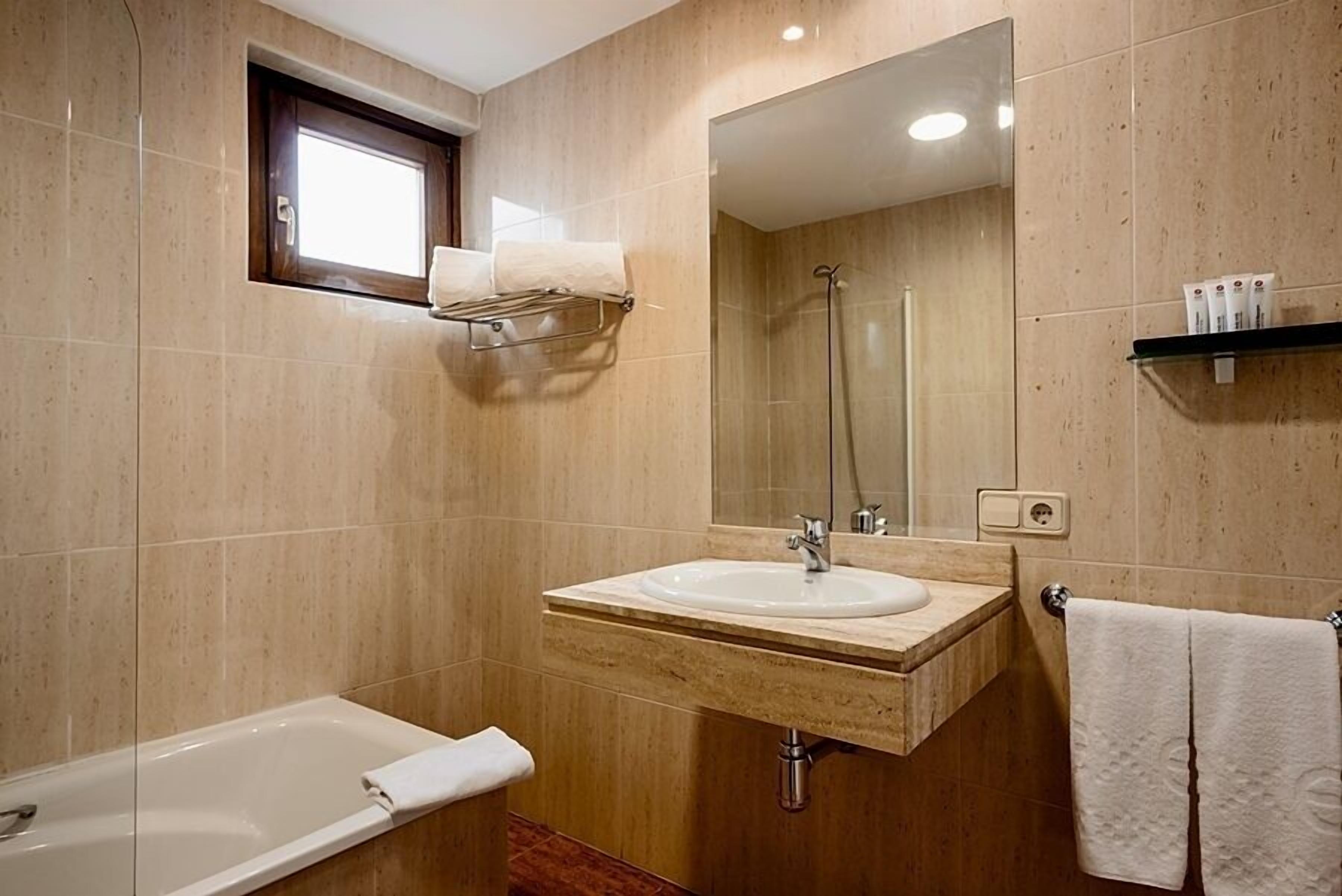 deep-soaking bathtub, eco-friendly toiletries, hair dryer, towels