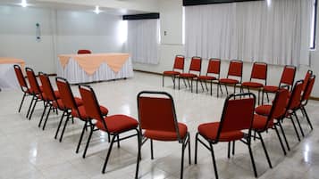 A conference room with a table and chairs arranged for a meeting.