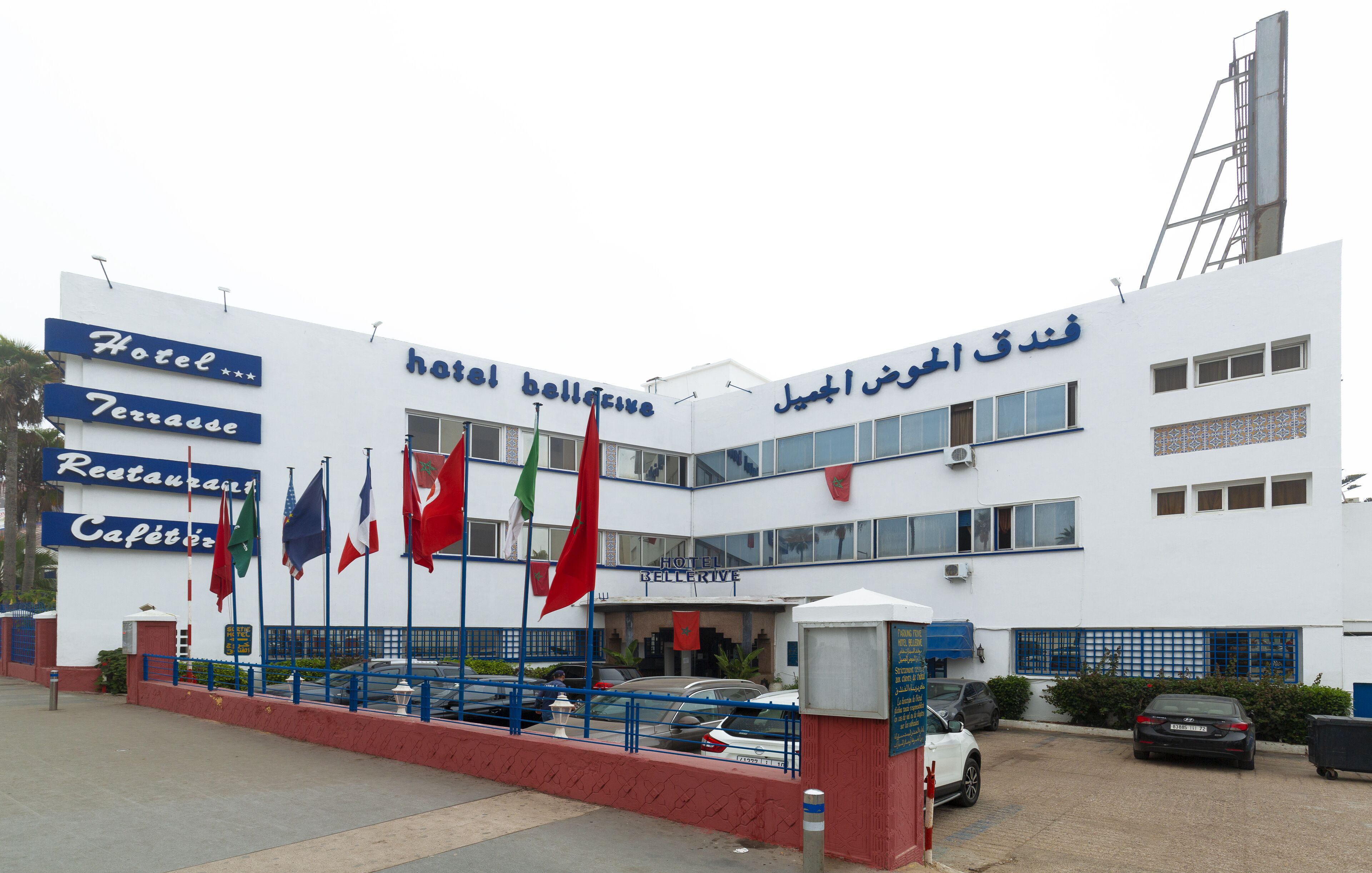 A hotel with a signboard indicating it has a restaurant and café.