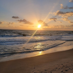 A beach with waves and a sunset. - The Driftwood Resort (Vero Beach)