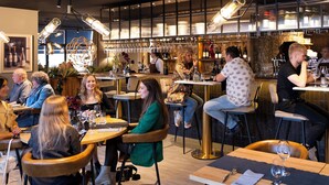 A restaurant interior with tables, chairs, and patrons. - Dormio Wijnhotel Valkenburg (Valkenburg aan de Geul)
