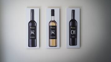 Three wine bottles with labels, each in a separate box.