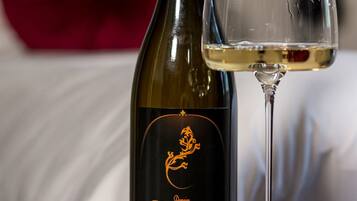 A bottle of Salamander Chardonnay 2013 wine and a glass of wine on a table.
