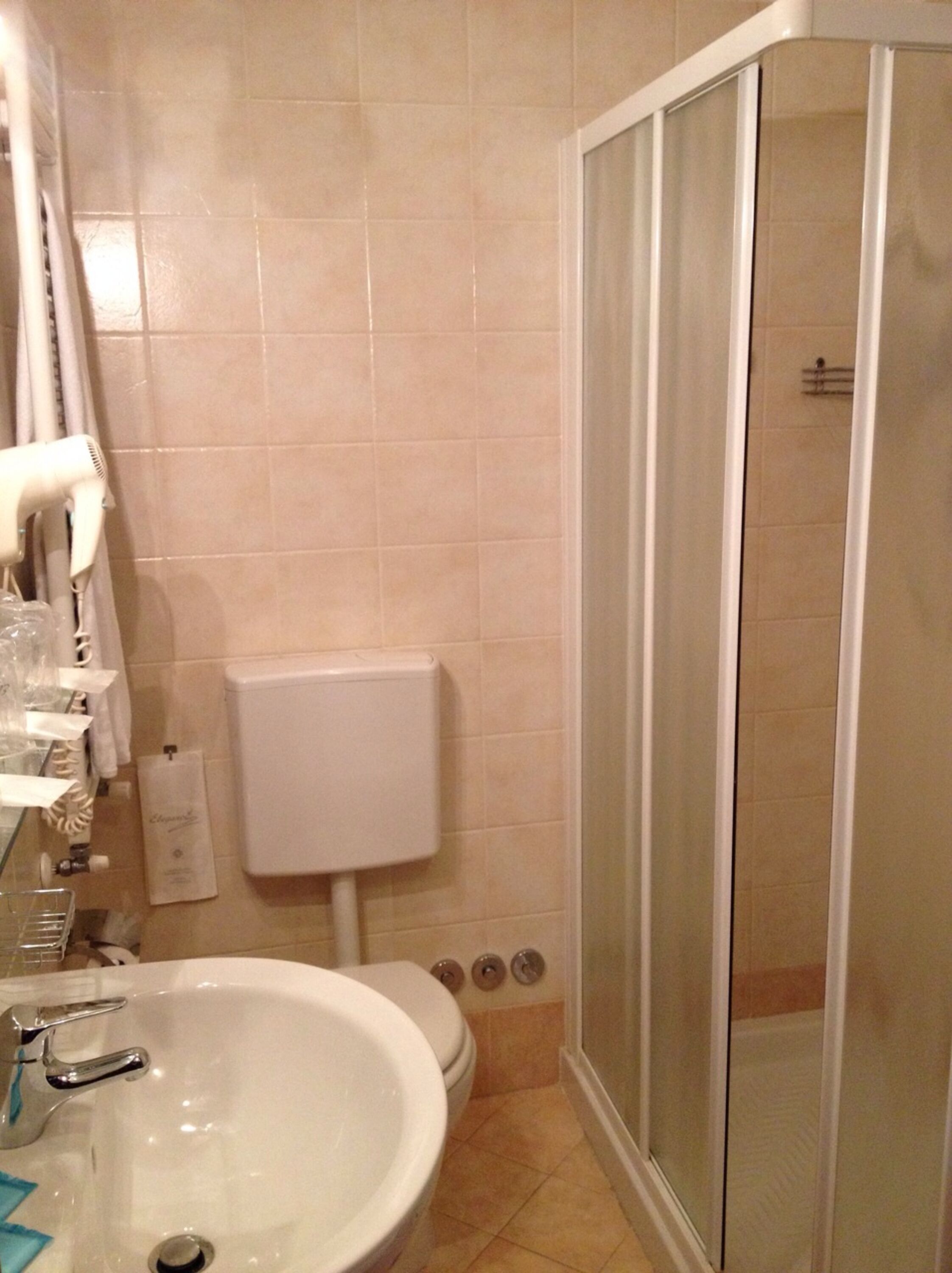 A bathroom with a sink, toilet, and shower.