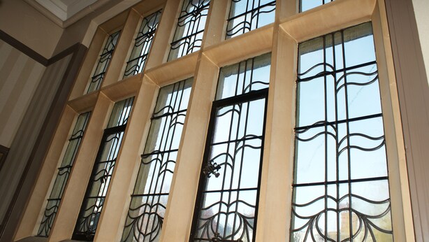 A building with multiple large windows featuring ornate metal grilles. - B+B York (York)