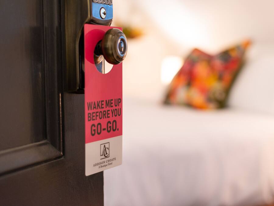 A door with a sign that reads "WAKE ME UP BEFORE YOU GO-GO."