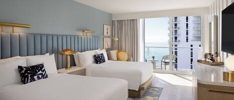 A hotel room with two beds, a large window, a balcony, and a TV.