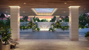 A covered outdoor area with a central light feature, surrounded by plants and a white fence. - The Sunny (Sunny Isles Beach)