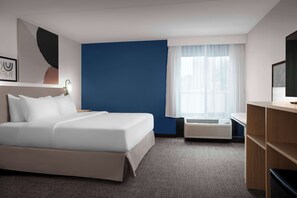 Premium bedding, desk, laptop workspace, blackout curtains