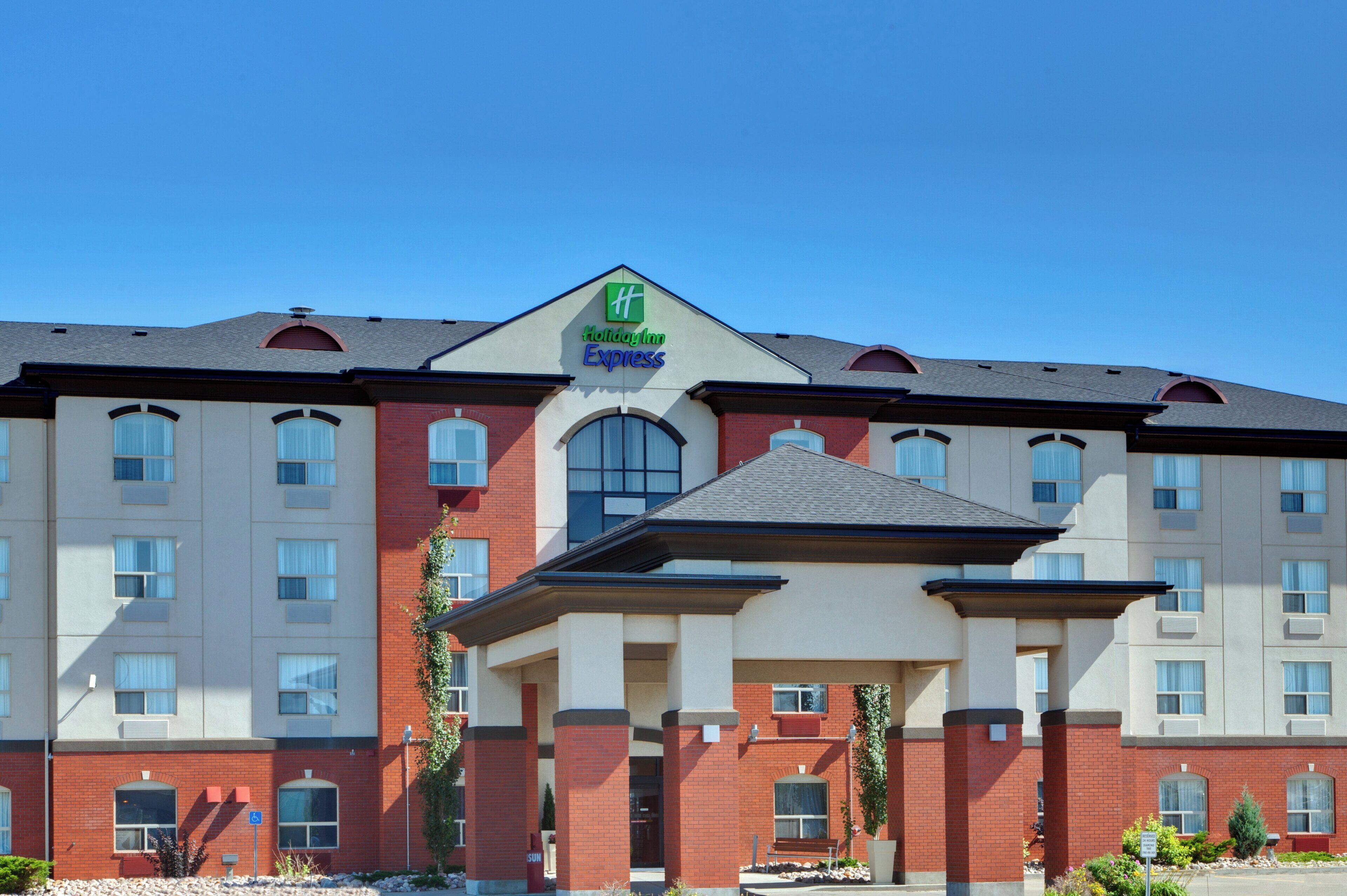 A Holiday Inn Express building with a symmetrical facade, multiple windows, and a central entrance.