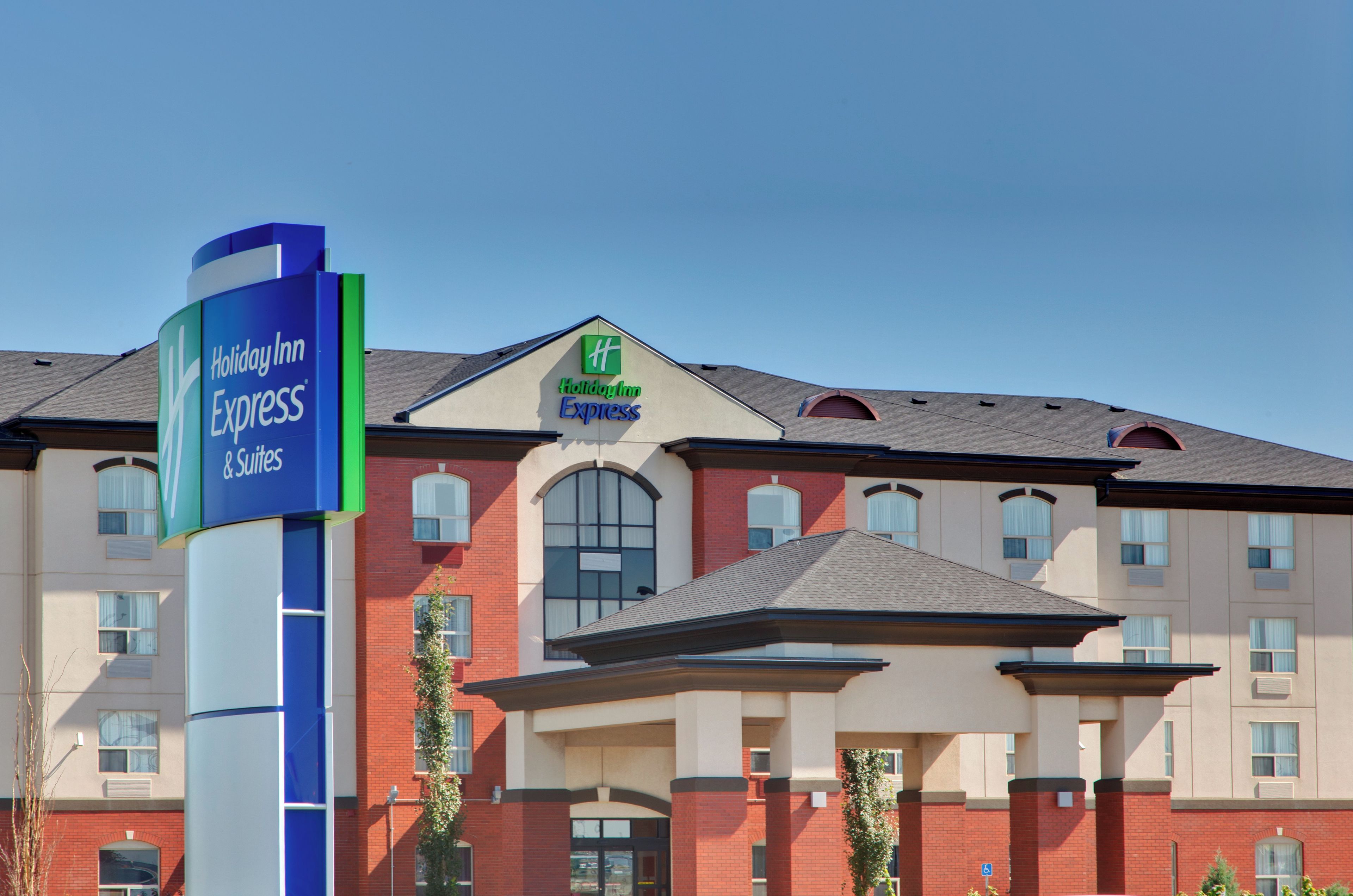 A Holiday Inn Express building with a prominent sign, a brick facade, and a flat roof.