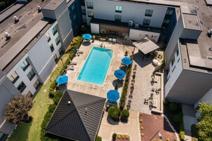 Seasonal outdoor pool, open 9:00 AM to 10:00 PM, pool umbrellas