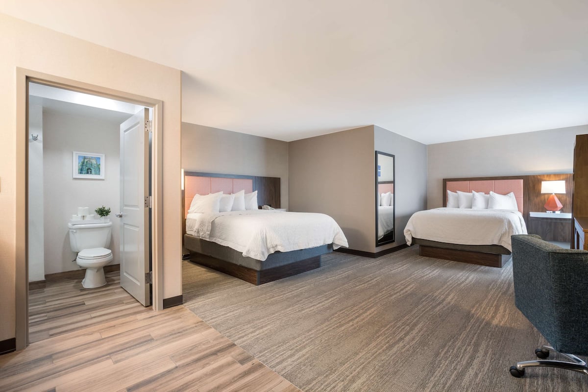 Premium bedding, desk, laptop workspace, blackout drapes