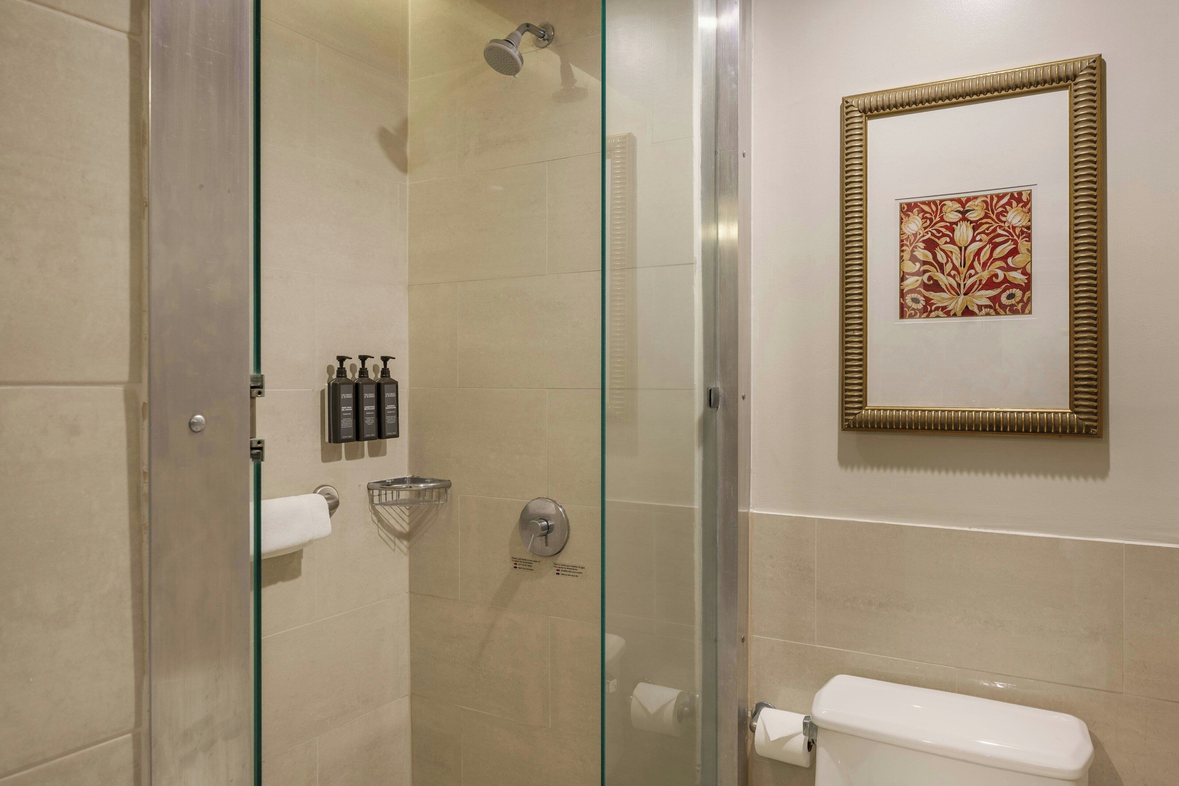 Combined shower/tub, designer toiletries, hair dryer, towels