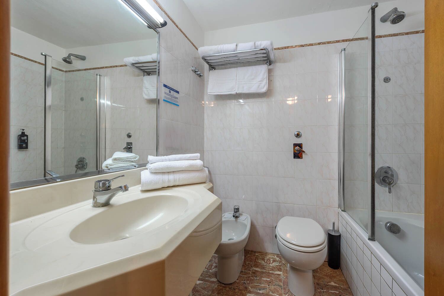 A modern bathroom with a sink, toilet, and shower.