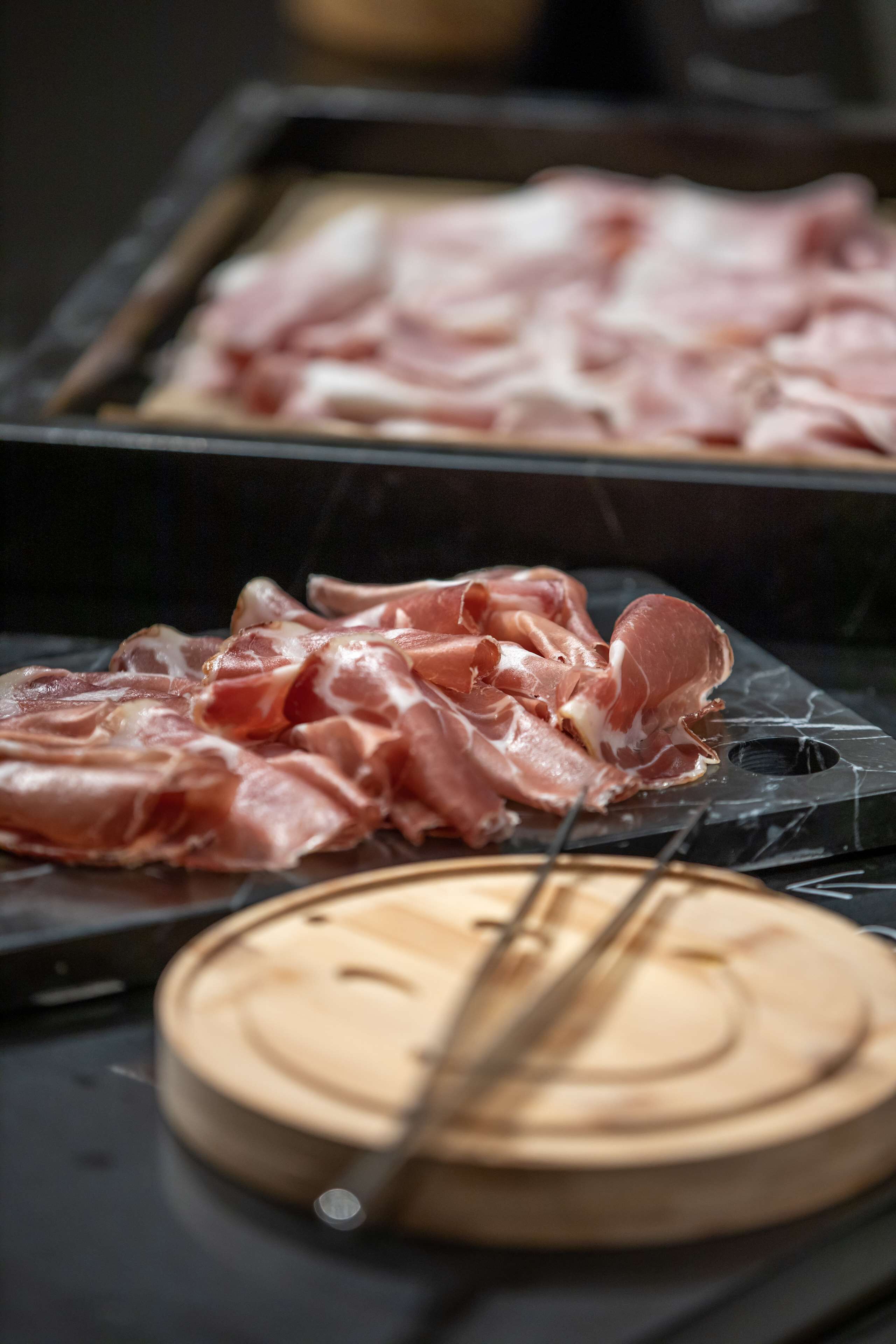 A kitchen counter with raw meat and a cutting board.