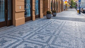 A building with European Union flags, Radisson hotel signage, and cobblestone pavement. - Radisson Blu Hotel, Prague (Prague)
