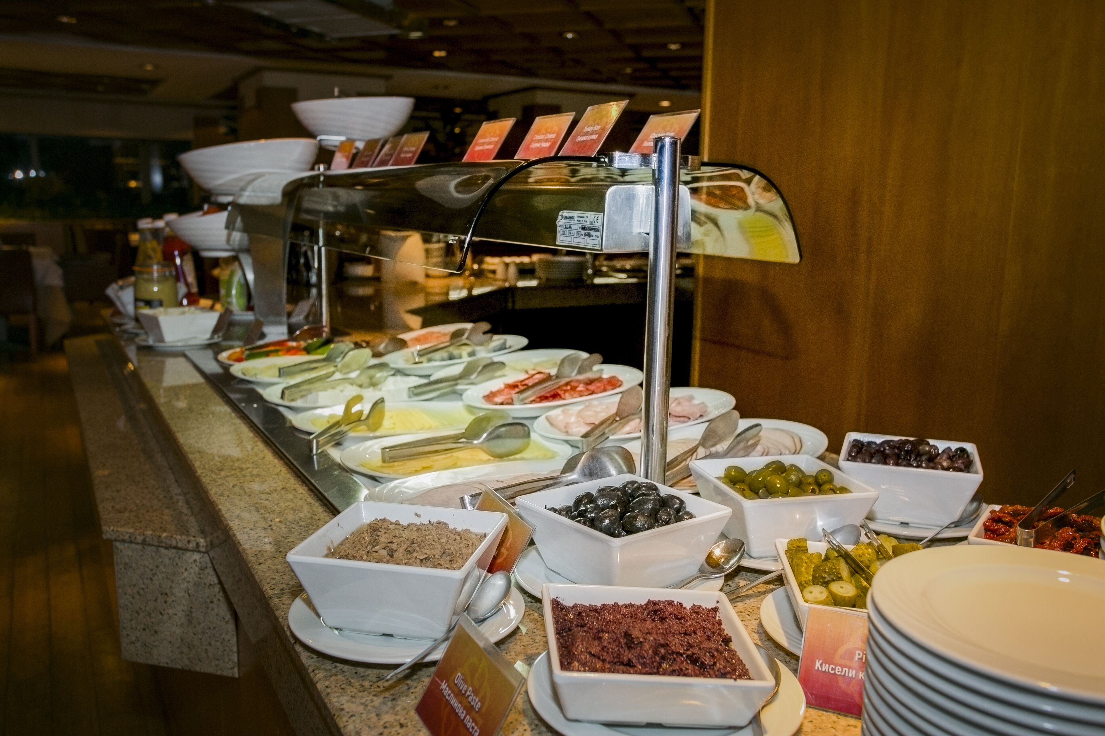 A buffet with various food items and condiments.