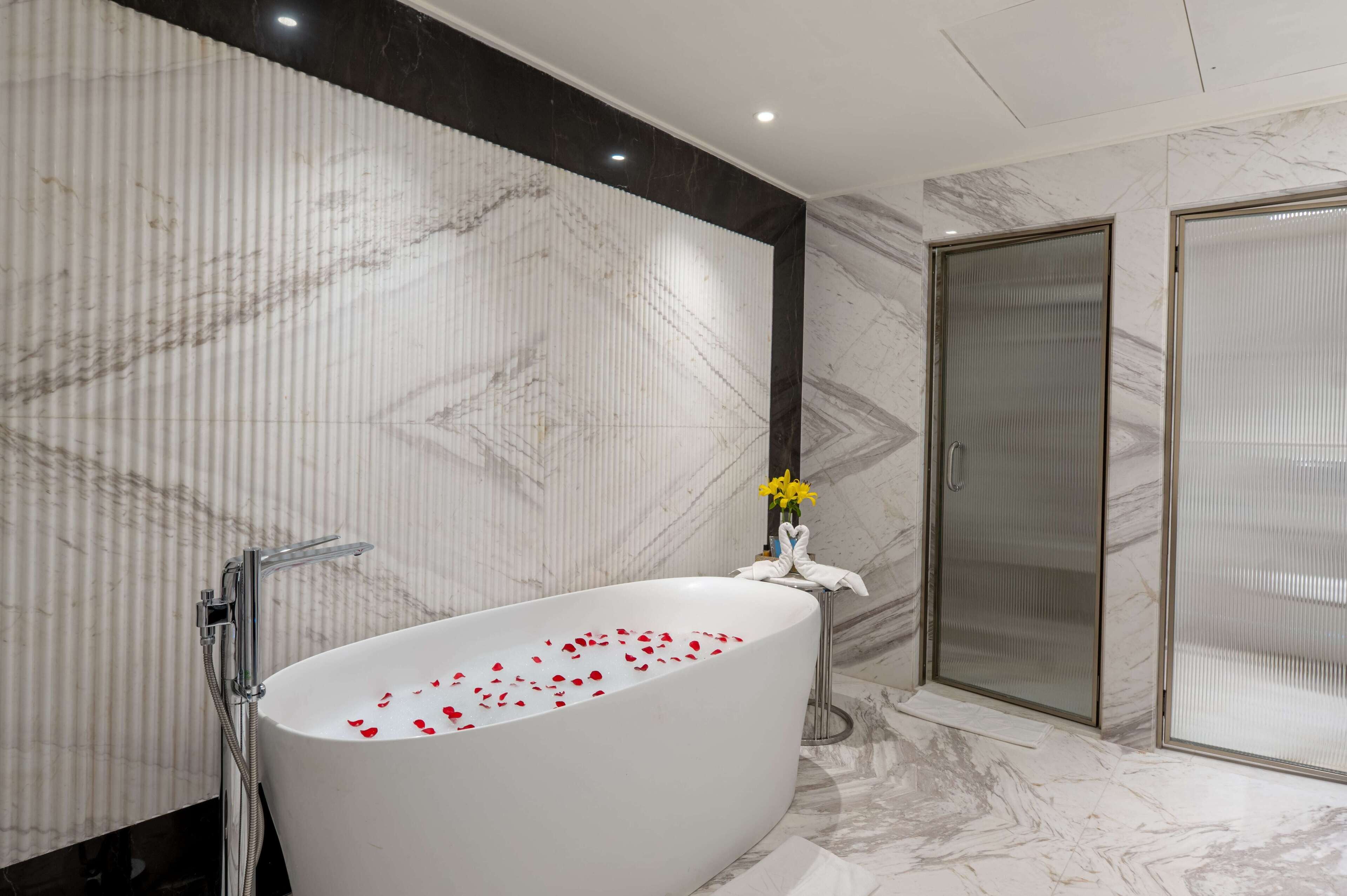 presidential suite, 1 bedroom, garden view | bathroom | combined shower/bathtub, rainfall showerhead, free toiletries