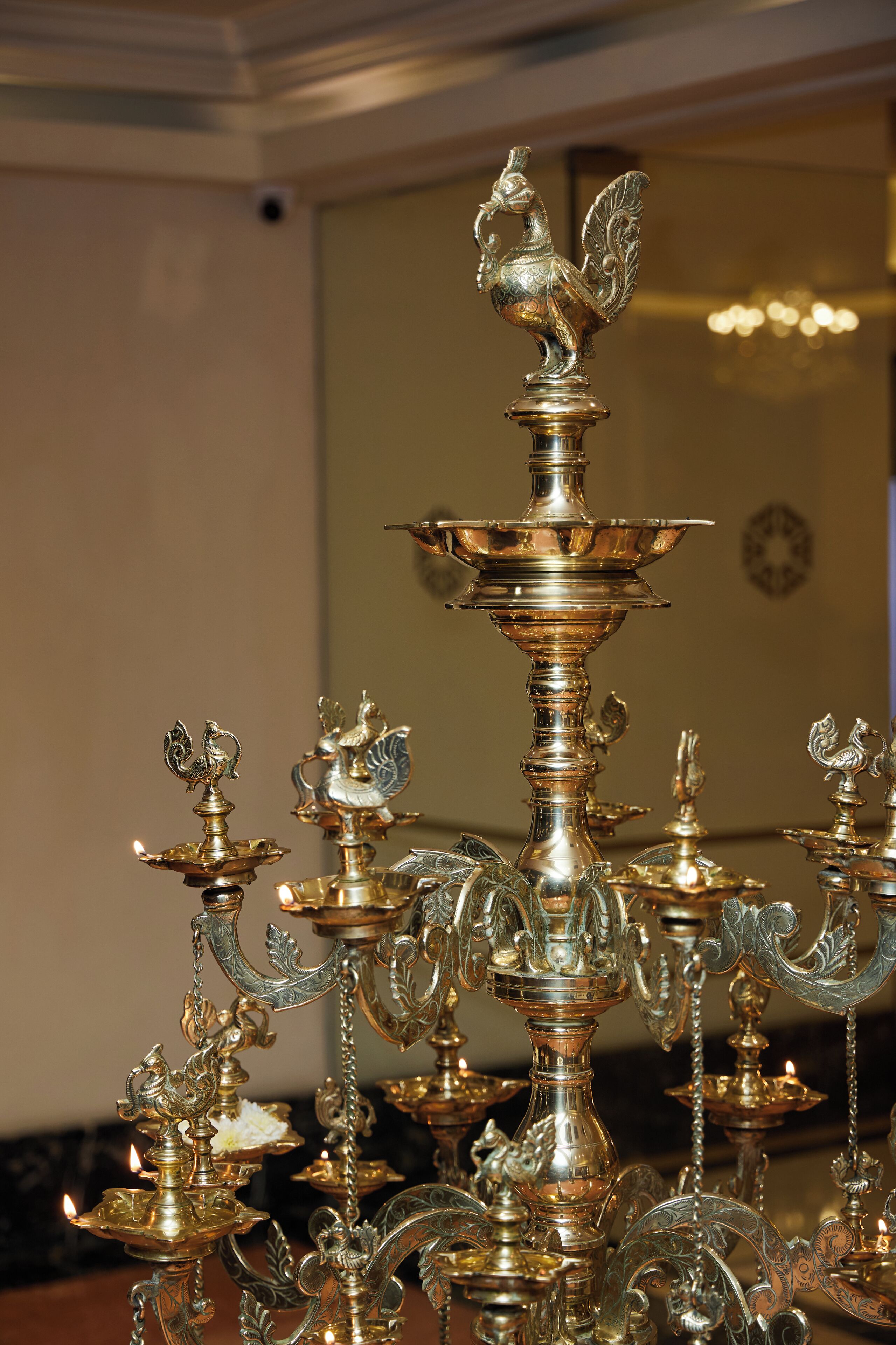 A chandelier with ornate metal designs and multiple light sources.